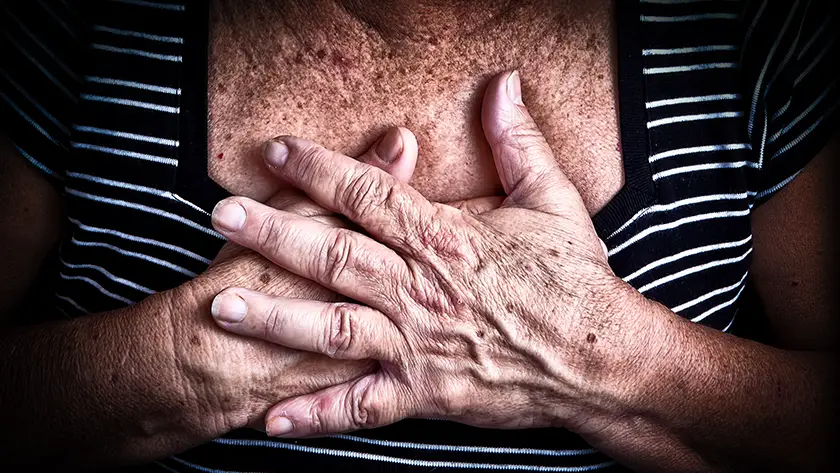 Photo of a woman holding her chest