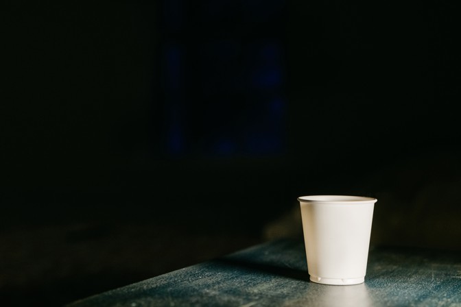 white cup on a blue table