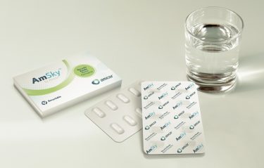 Amcor's AmSky packaging next to a glass of water[credit: Amcor].