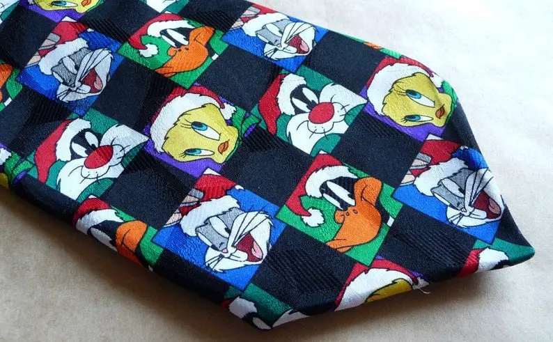 A Looney Tunes necktie featuring Tweety Bird, Dafffy Duck and Bugs Bunny in Santa hats.