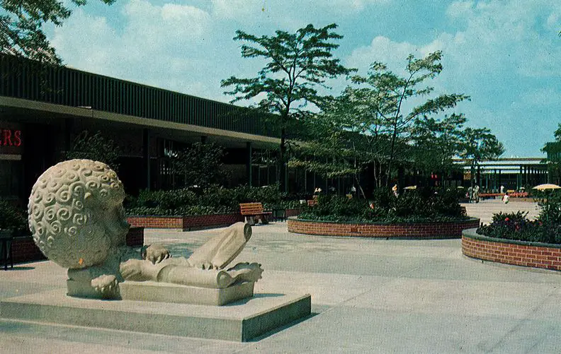 Vintage postcard of a whimsical lion sculpture in an outdoor plaza at a shopping mall