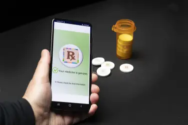 People can use a smartphone app to activate a new cyberphysical watermark to detect whether the medication they are taking is real or fake. Purdue biomedical engineers have developed the cyberphysical watermark as a way to reduce fake medications [Credit: Purdue University photo/John Underwood].