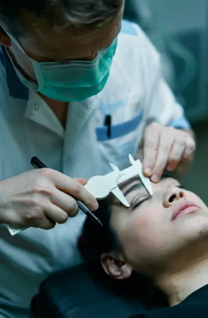 A Cosmetician Measuring a Patient Eyelid