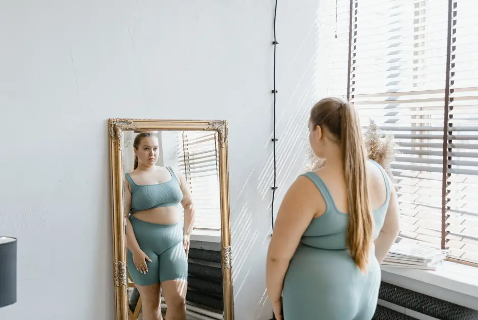 A Woman in Activewear Looking at Her Reflection