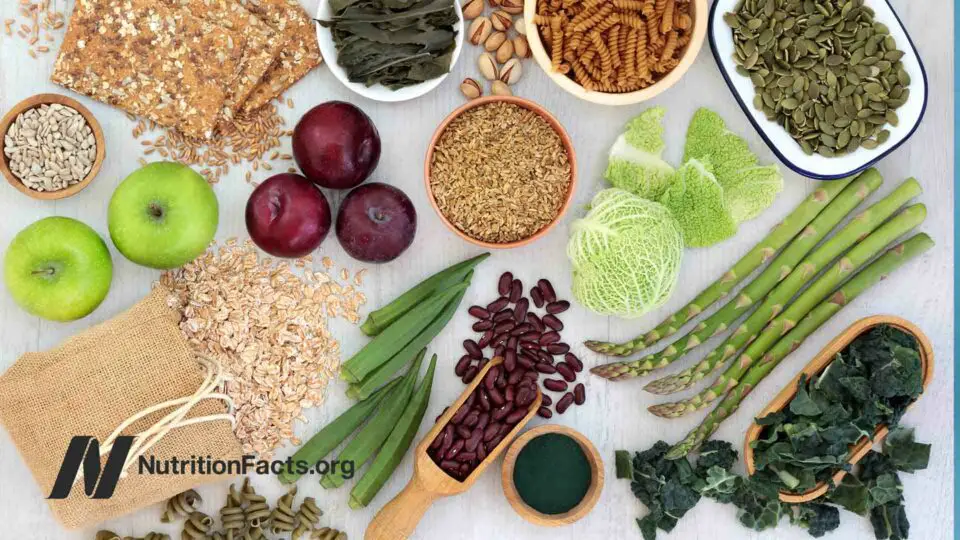 High fiber super foods with whole grain crackers, fruit, vegetables, whole wheat pasta, grains, and nuts