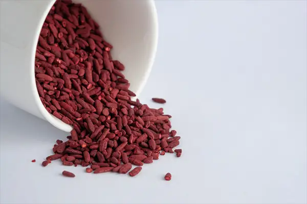 red yeast rice spilling out of bowl | Red Yeast Rice